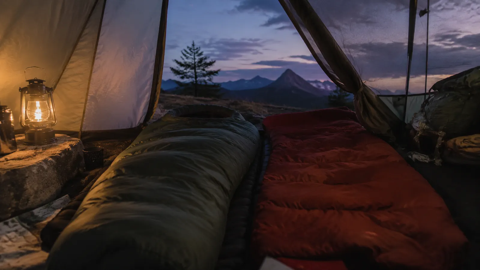 Teton Sports Celsius mummy sleeping bag laid out on a tent floor next to a rectangular bag for size comparison